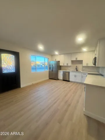 a view of a kitchen with a sink and a stove top oven