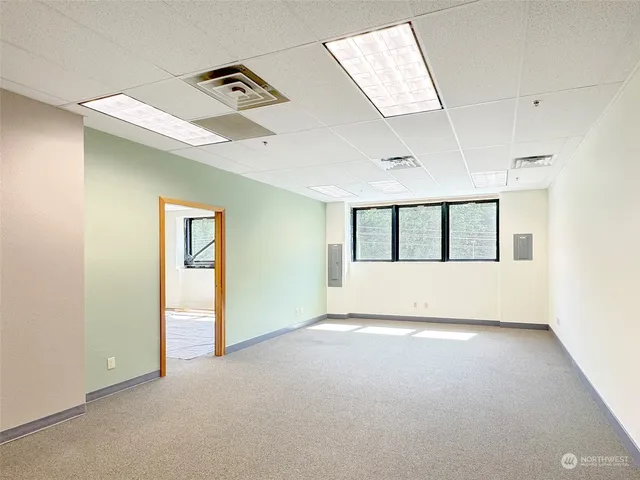 an empty room with windows and closet