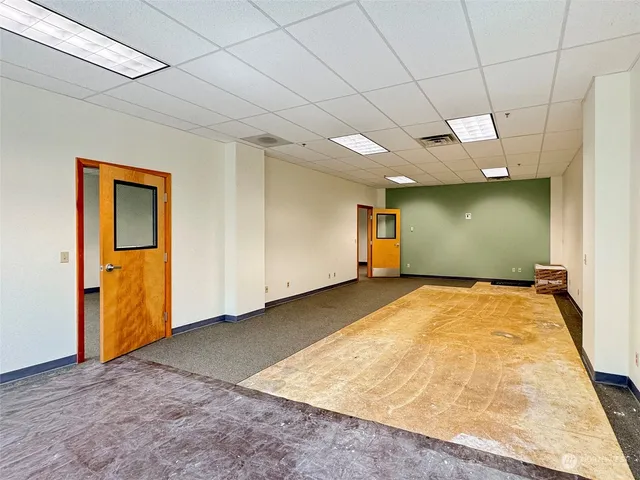 a small white car parked in front of a building