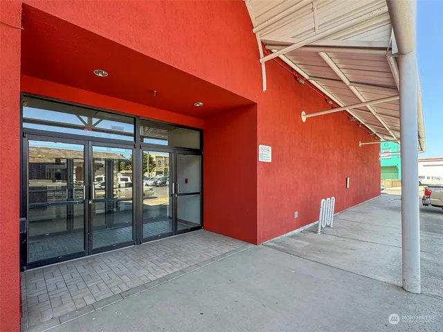 a backyard of a house with barbeque oven table and chairs