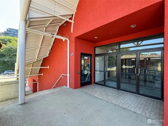 a lobby with a couch and floor to ceiling window