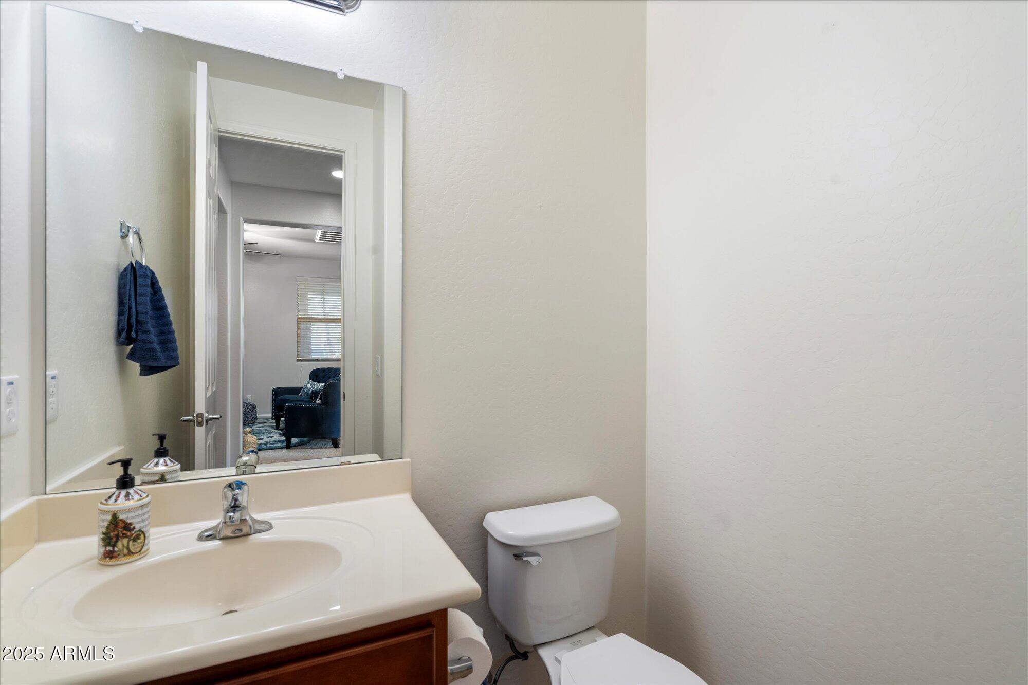 9010 West Ruth Avenue Peoria, AZ 85345 - Photo 13 of 26 a bathroom with a sink a toilet and mirror
