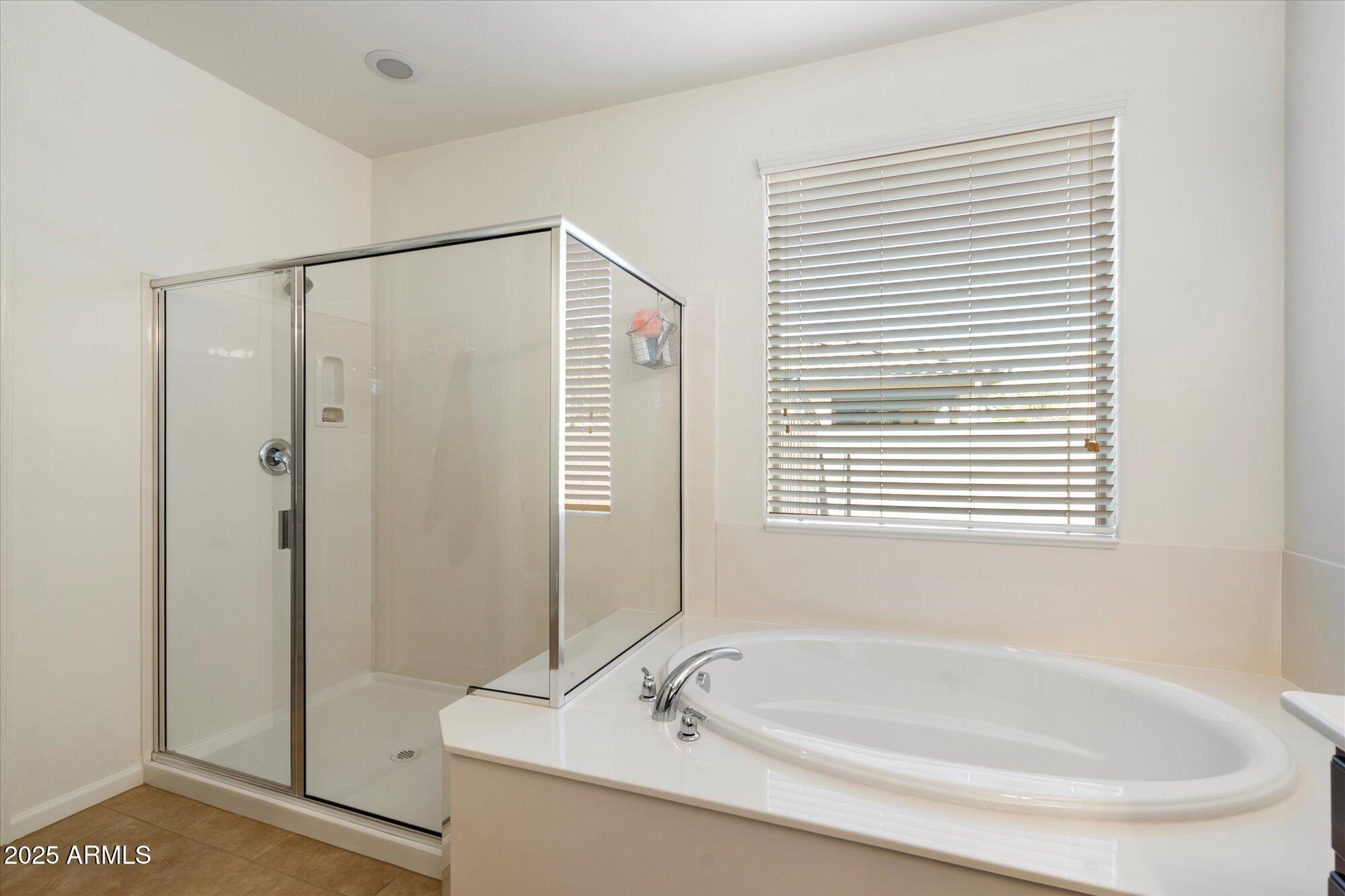 9010 West Ruth Avenue Peoria, AZ 85345 - Photo 17 of 26 a bathroom with a tub and a shower