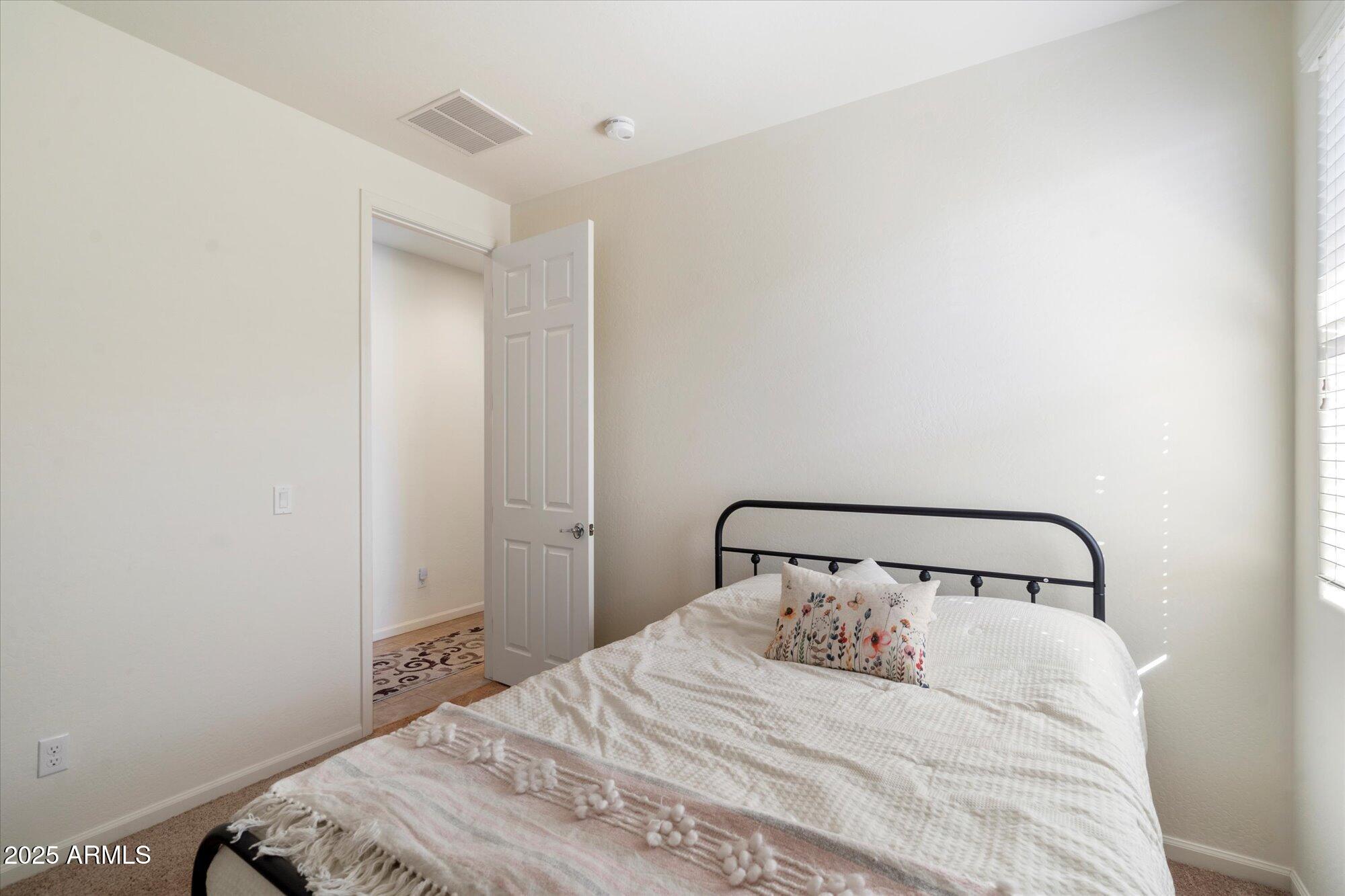 9010 West Ruth Avenue Peoria, AZ 85345 - Photo 21 of 26 a bedroom with a bed and a mirror