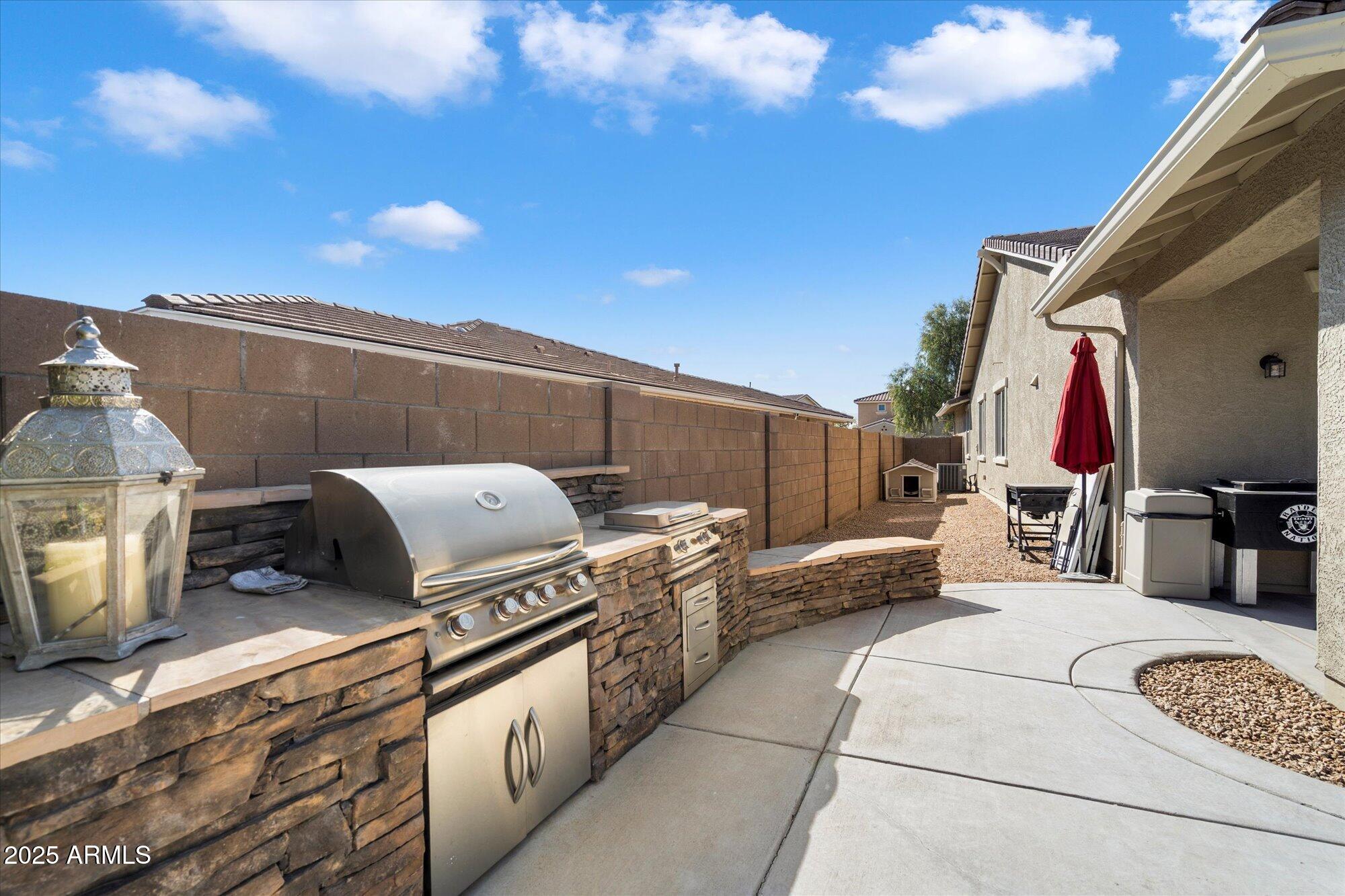 9010 West Ruth Avenue Peoria, AZ 85345 - Photo 23 of 26 a view of a kitchen with furniture and a stove