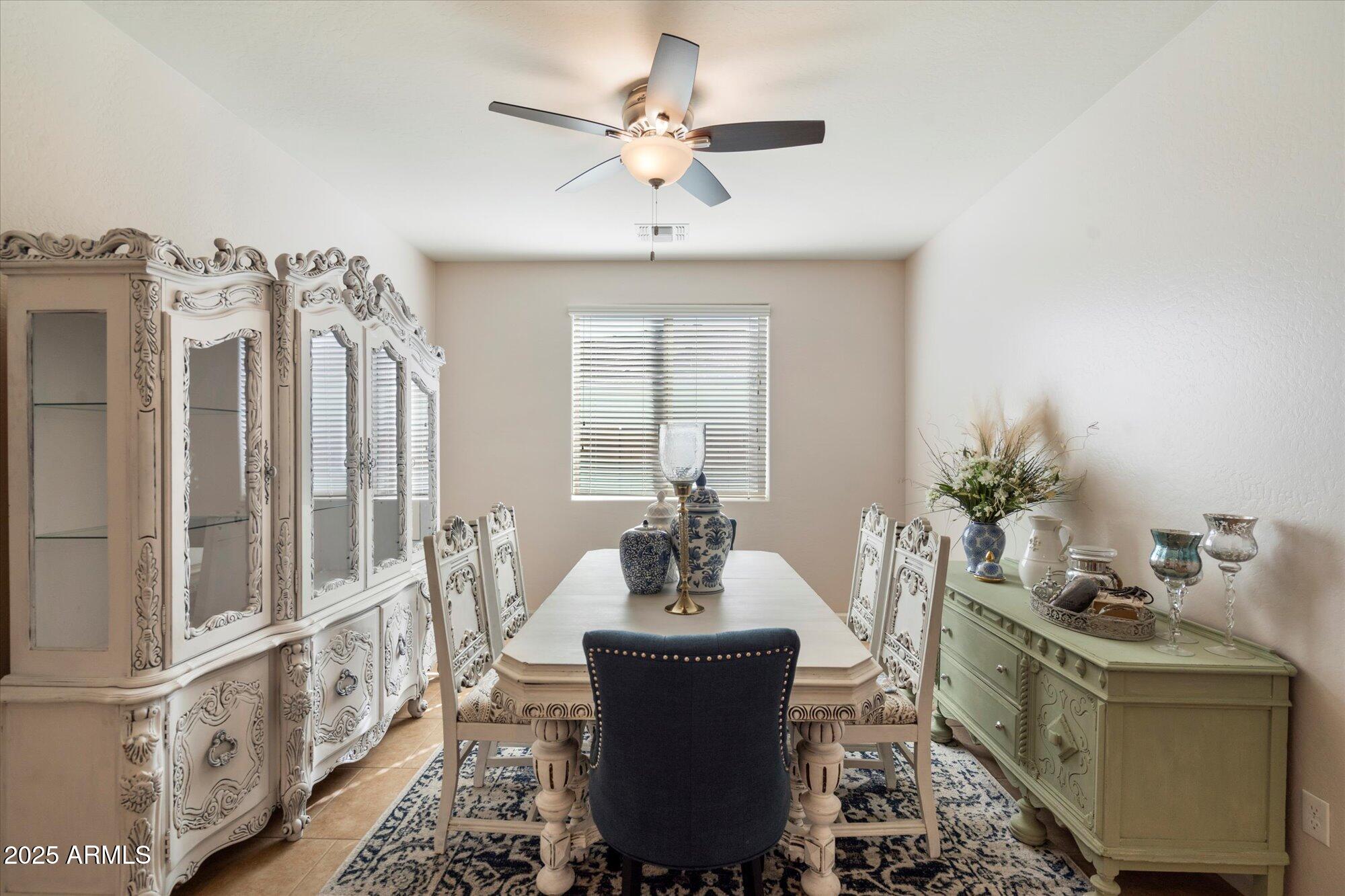9010 West Ruth Avenue Peoria, AZ 85345 - Photo 4 of 26 a living room with furniture and a chandelier