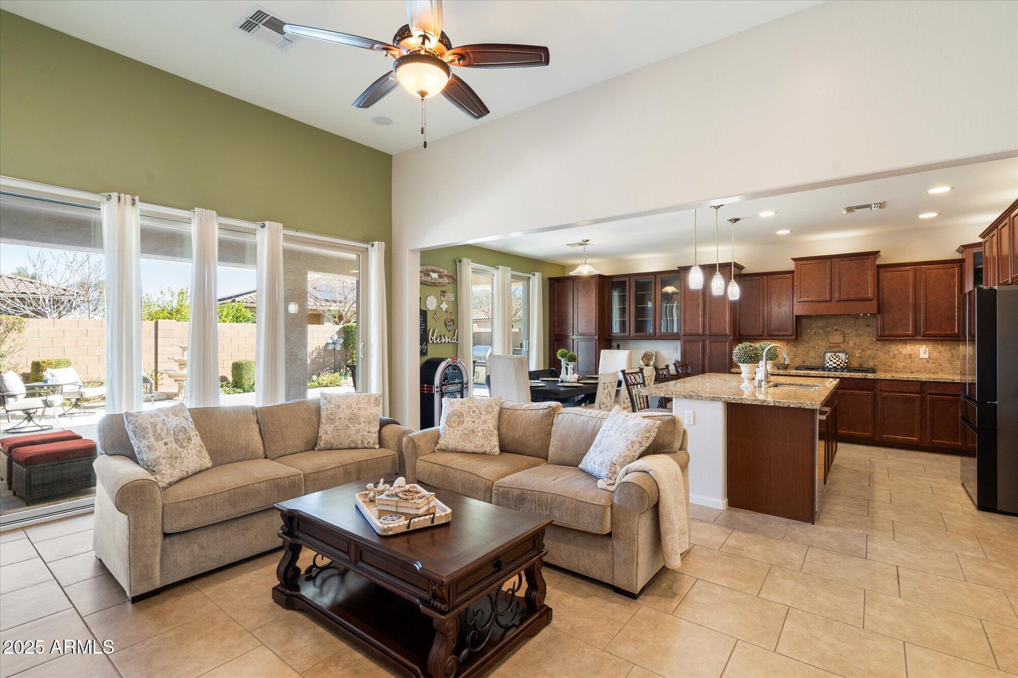 9010 West Ruth Avenue Peoria, AZ 85345 - Photo 5 of 26 a living room with furniture kitchen view and a large window