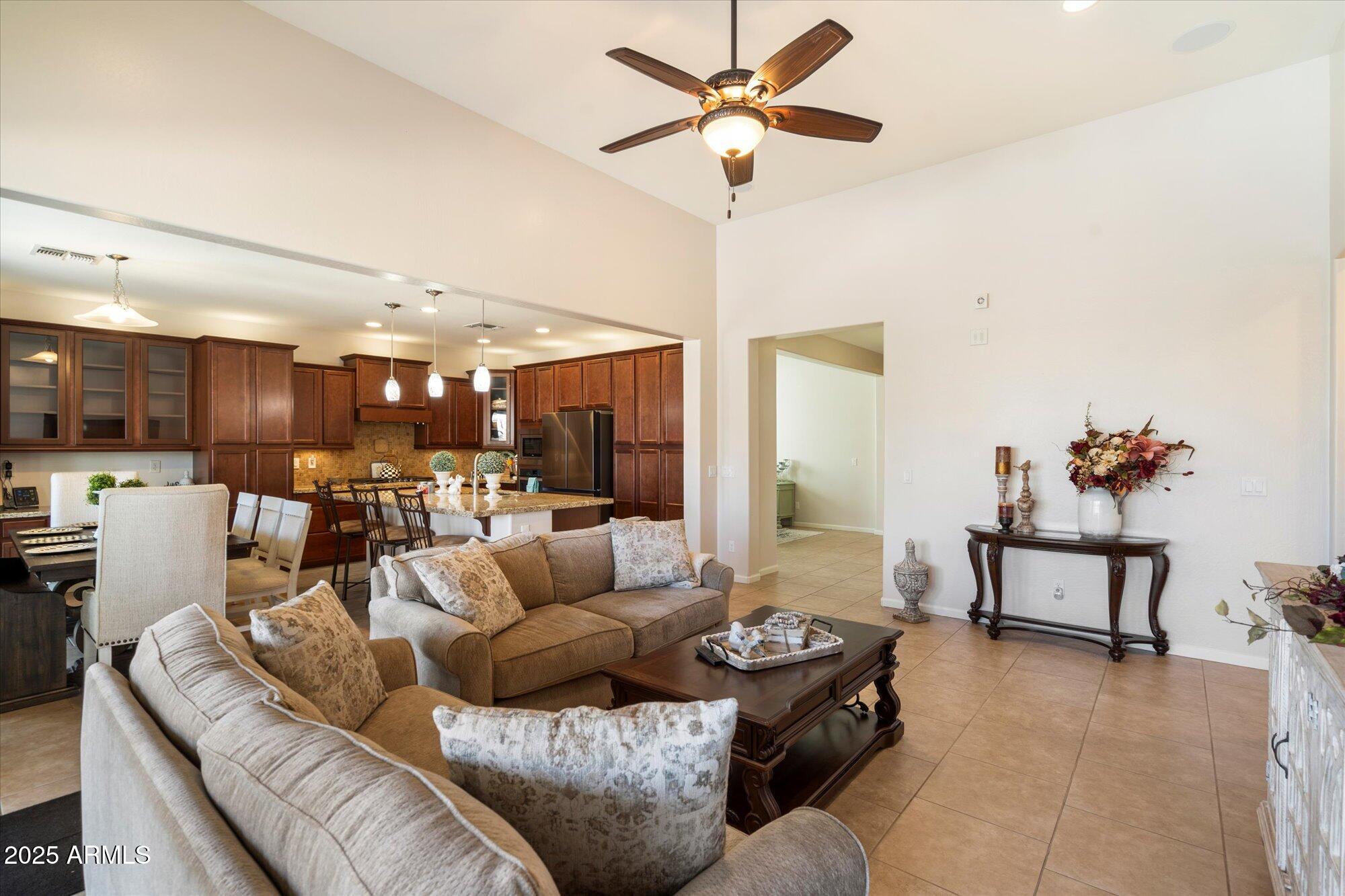 9010 West Ruth Avenue Peoria, AZ 85345 - Photo 7 of 26 a living room with furniture and a chandelier