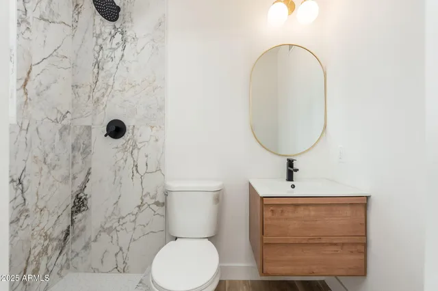 a bathroom with a toilet sink and mirror