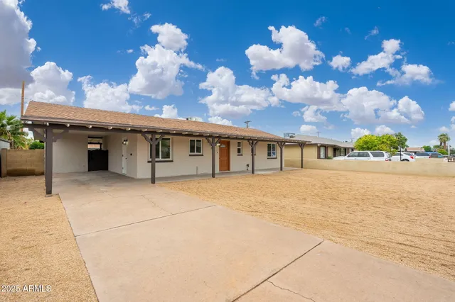 a front view of a house with a yard and a garage