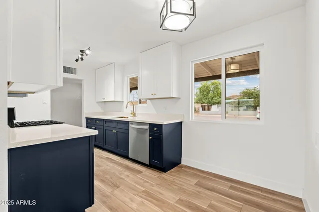 a kitchen with a stove window and cabinets