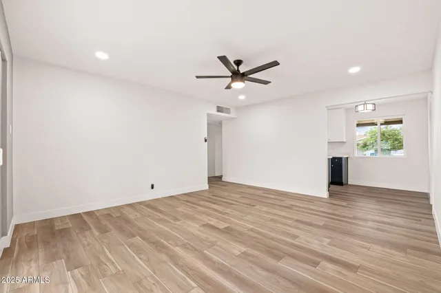 wooden floor in an empty room with a window