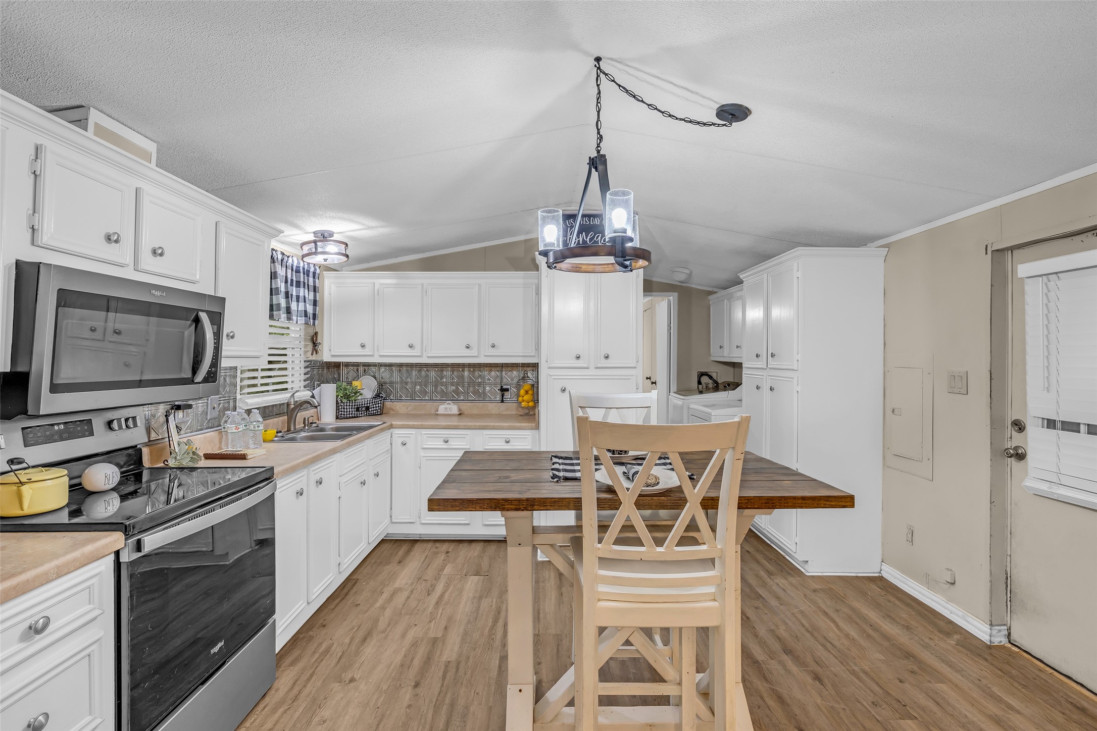 188 Chrissy Lane Trinity, TX 75862 - Photo 9 of 25 a kitchen with stainless steel appliances granite countertop a stove top oven a sink dishwasher a dining table and chairs with wooden floor