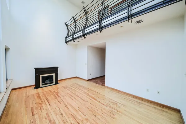 a view of empty room with wooden floor