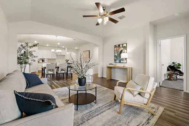 a living room with furniture and wooden floor