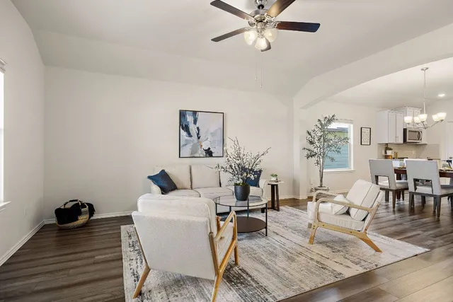 a living room with furniture and a chandelier