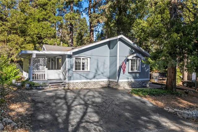 a view of a house with a yard and trees