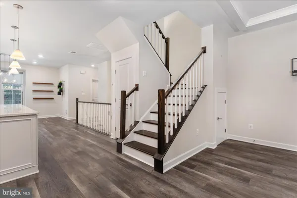 a view of entryway and hall with wooden floor