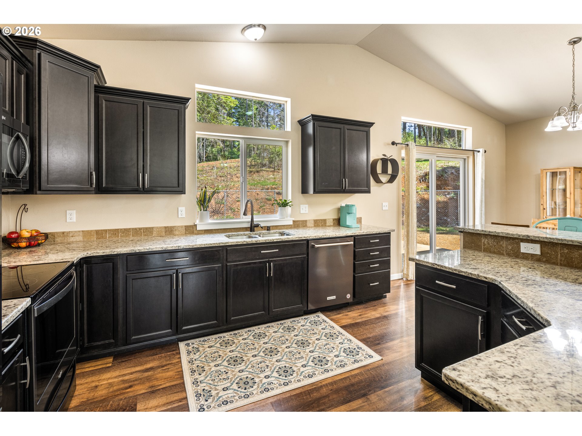 1452 Lacock-Kelchner Road Underwood, WA 98651 - Photo 11 of 40 a kitchen with granite countertop a sink stainless steel appliances and cabinets