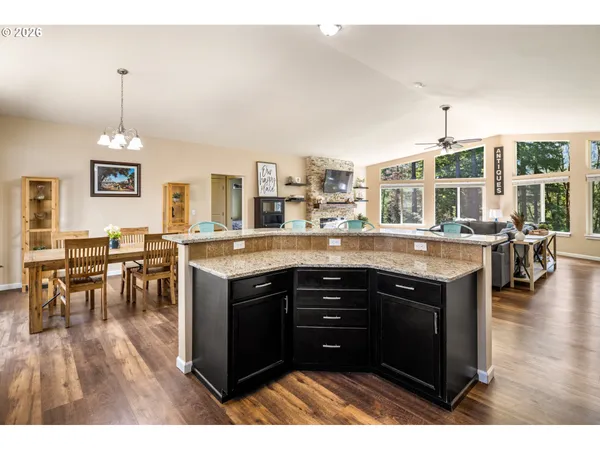 a kitchen with stainless steel appliances granite countertop a stove and cabinets
