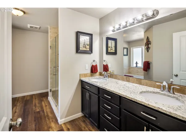 a bathroom with a granite countertop sink and a mirror