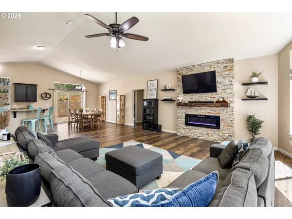 a living room with furniture a fireplace and a flat screen tv