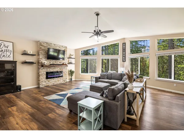 a living room with furniture a fireplace and a flat screen tv