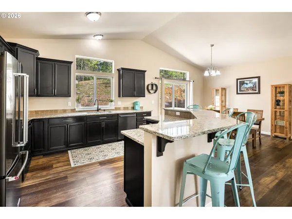 a kitchen with a stove a refrigerator and a dining table