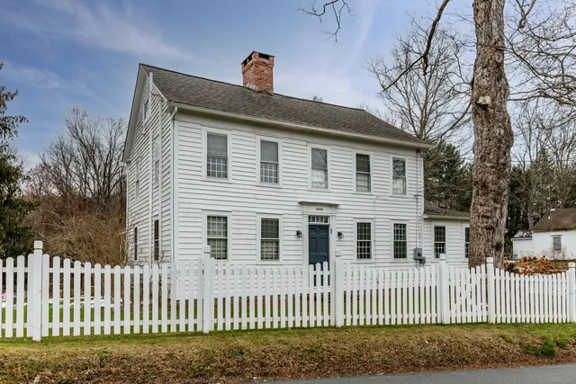 a front view of a house with a fence