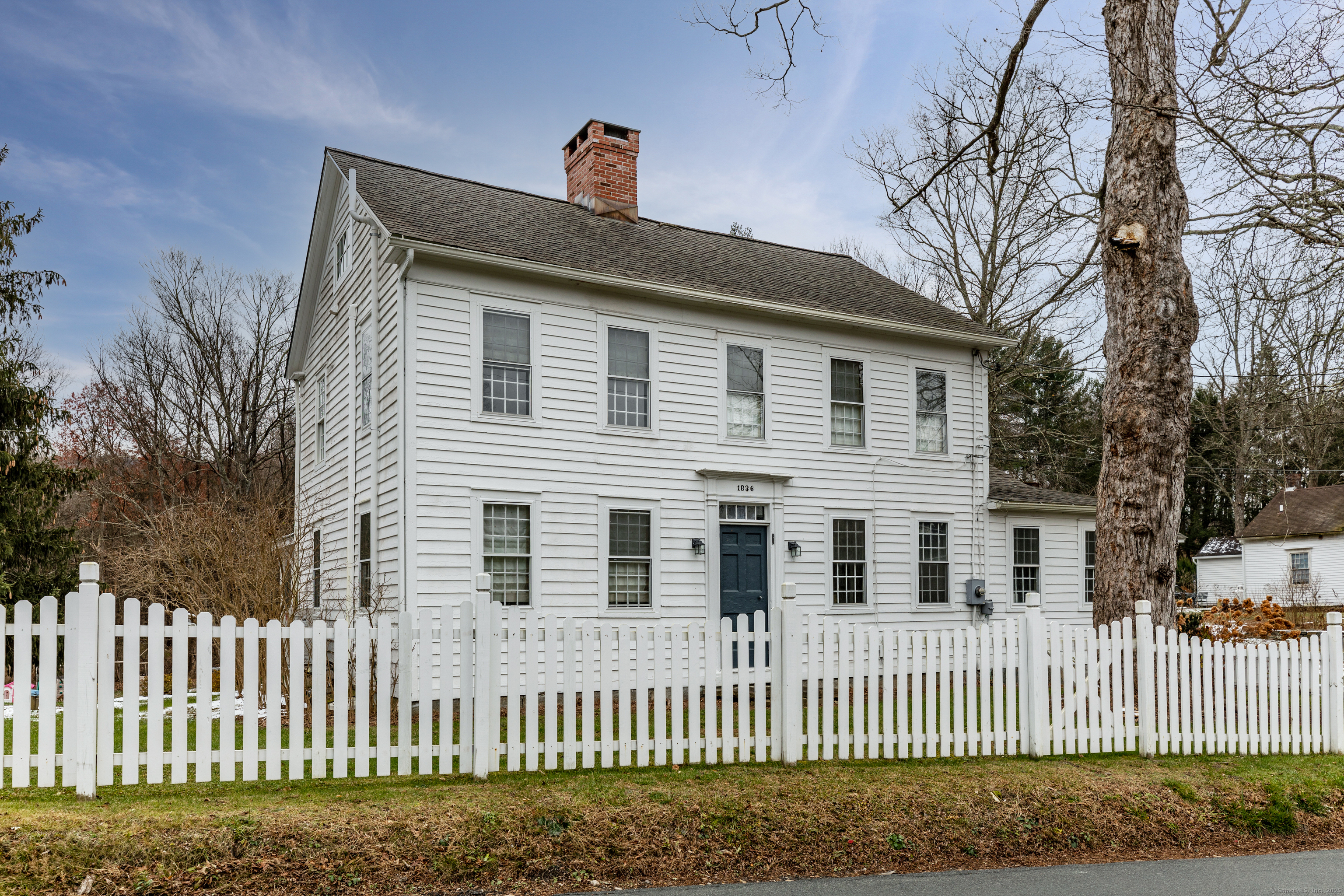 12 South Kent Road New Milford, CT 06755 - Photo 2 of 31 a front view of a house with a fence