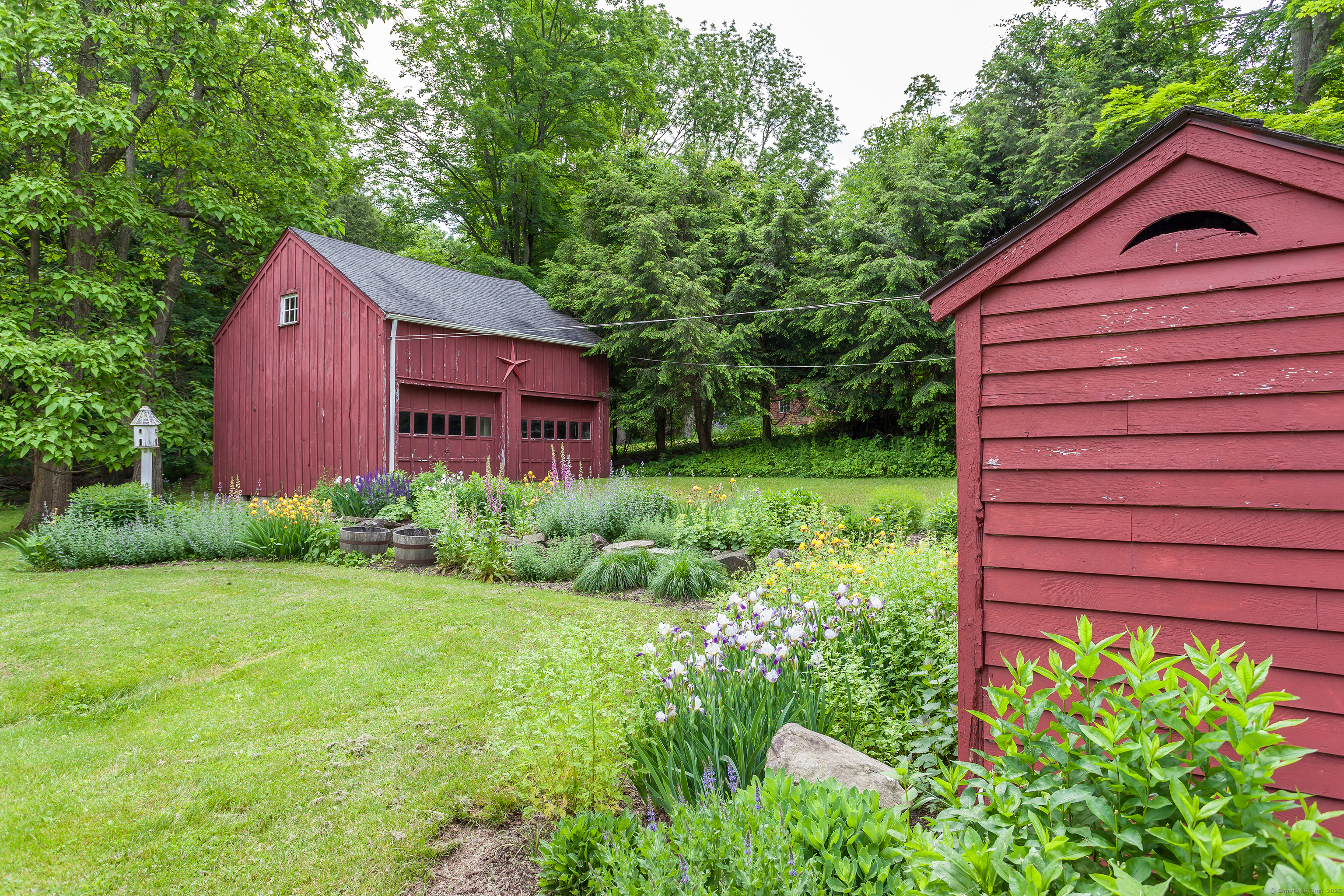 12 South Kent Road New Milford, CT 06755 - Photo 27 of 31 a view of a backyard with plants and large tree