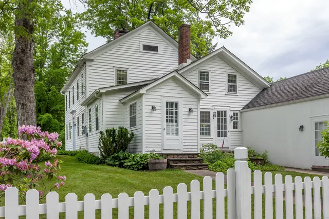 a front view of house with a garden