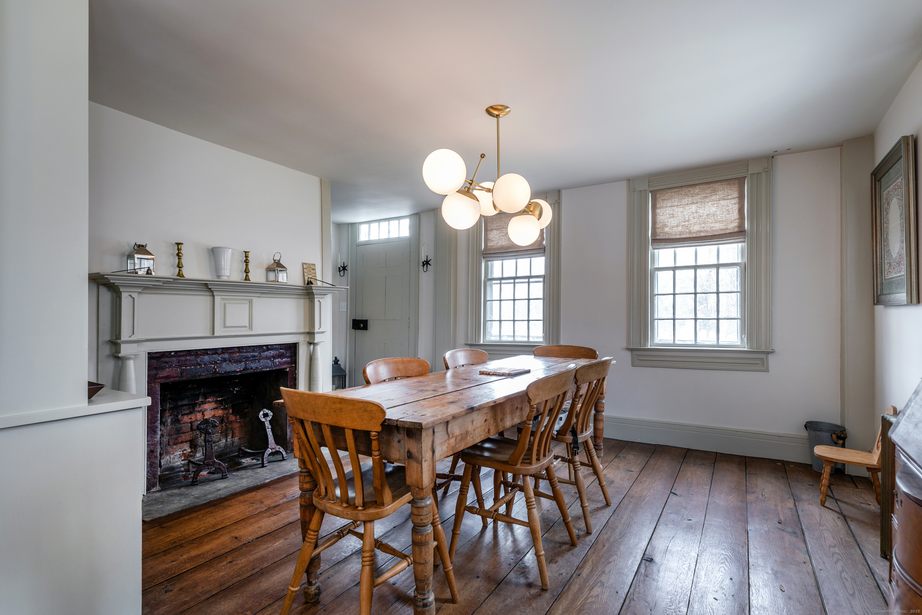 12 South Kent Road New Milford, CT 06755 - Photo 7 of 31 a dining room with wooden floor a chandelier a wooden table and chairs