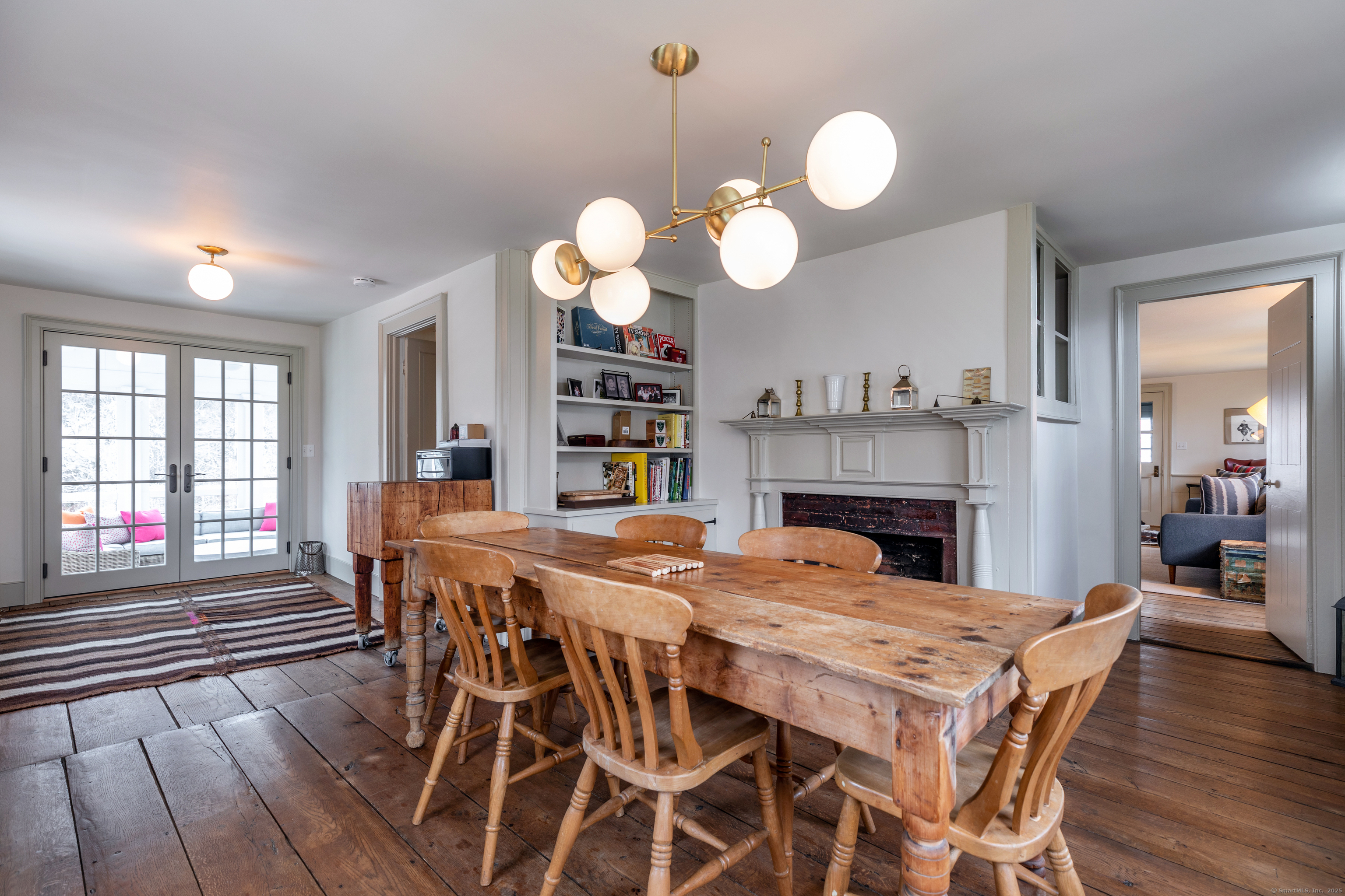 12 South Kent Road New Milford, CT 06755 - Photo 8 of 31 a dining room with furniture a large window and wooden floor
