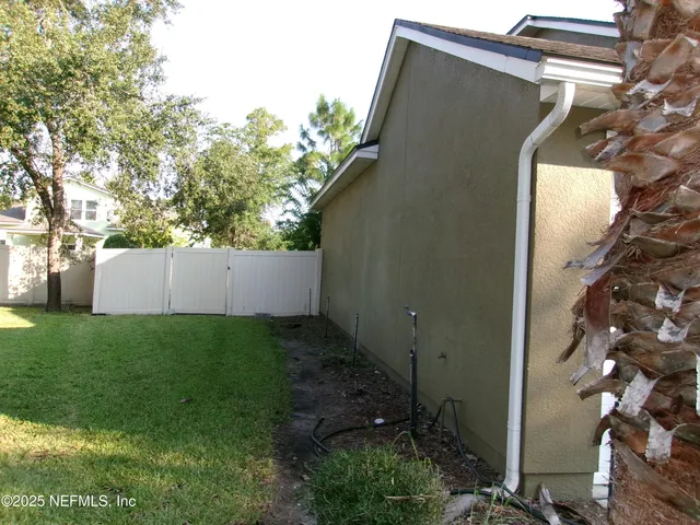 a view of a big yard with an outdoor seating