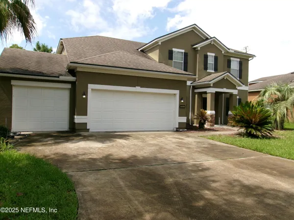 a front view of a house with a yard and garage
