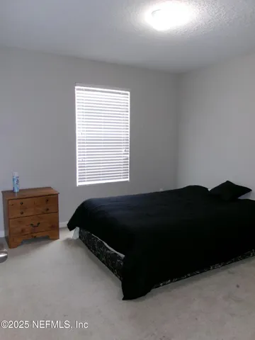 a view of a patio with table and chairs under an umbrella