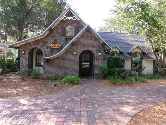 a kitchen with stainless steel appliances a sink a refrigerator a stove and wooden floors
