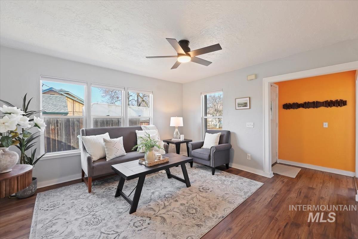 3111 West Palouse Street Boise, ID 83705 - Photo 13 of 32 Living room with a textured ceiling, dark wood-type flooring, and a ceiling fan