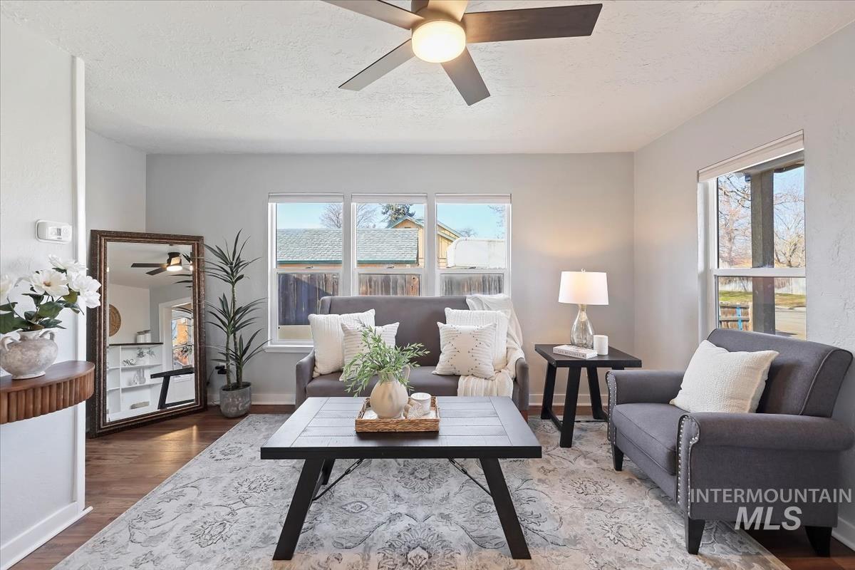 3111 West Palouse Street Boise, ID 83705 - Photo 14 of 32 Living area with ceiling fan, wood finished floors, and a textured ceiling