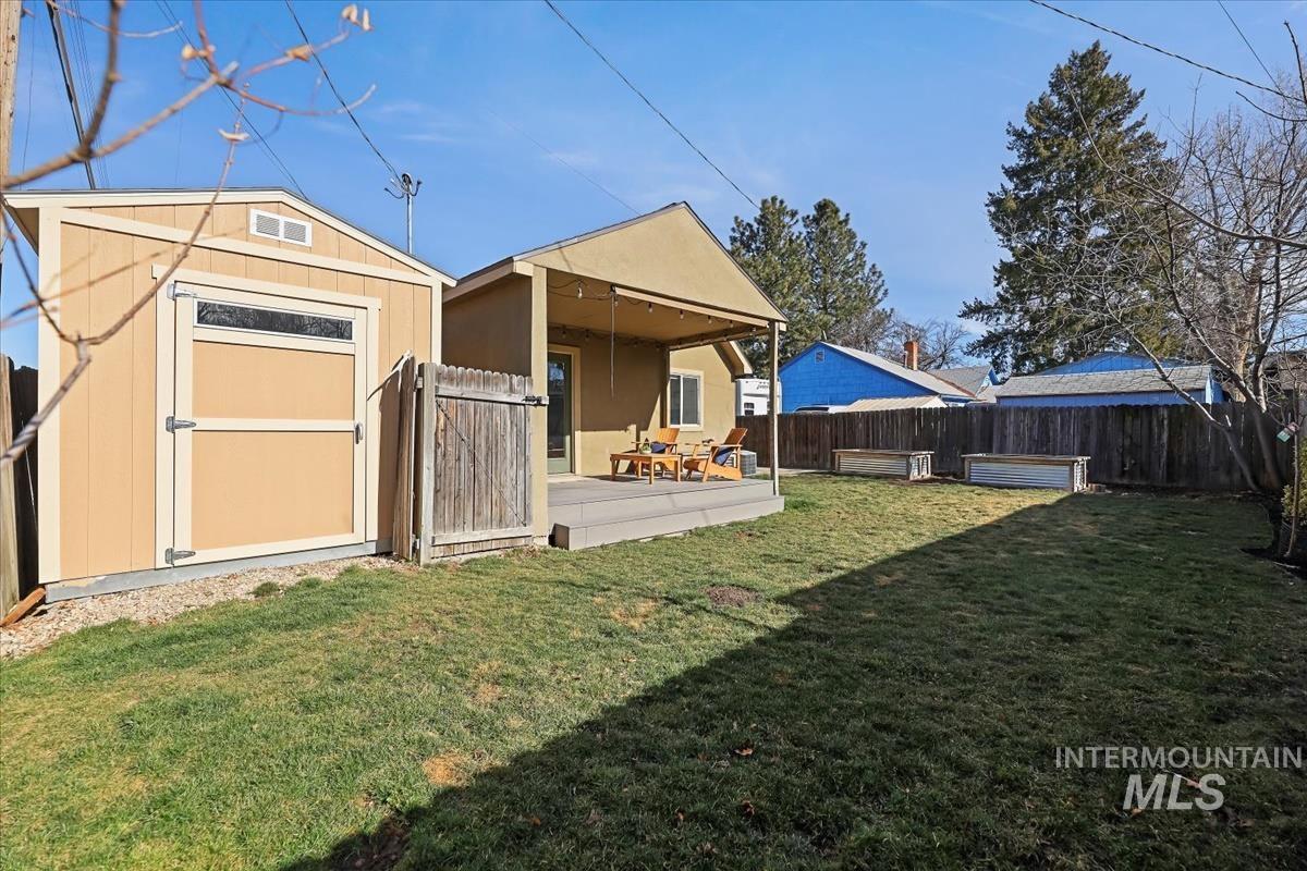 3111 West Palouse Street Boise, ID 83705 - Photo 30 of 32 Back of property with a fenced backyard and a storage shed
