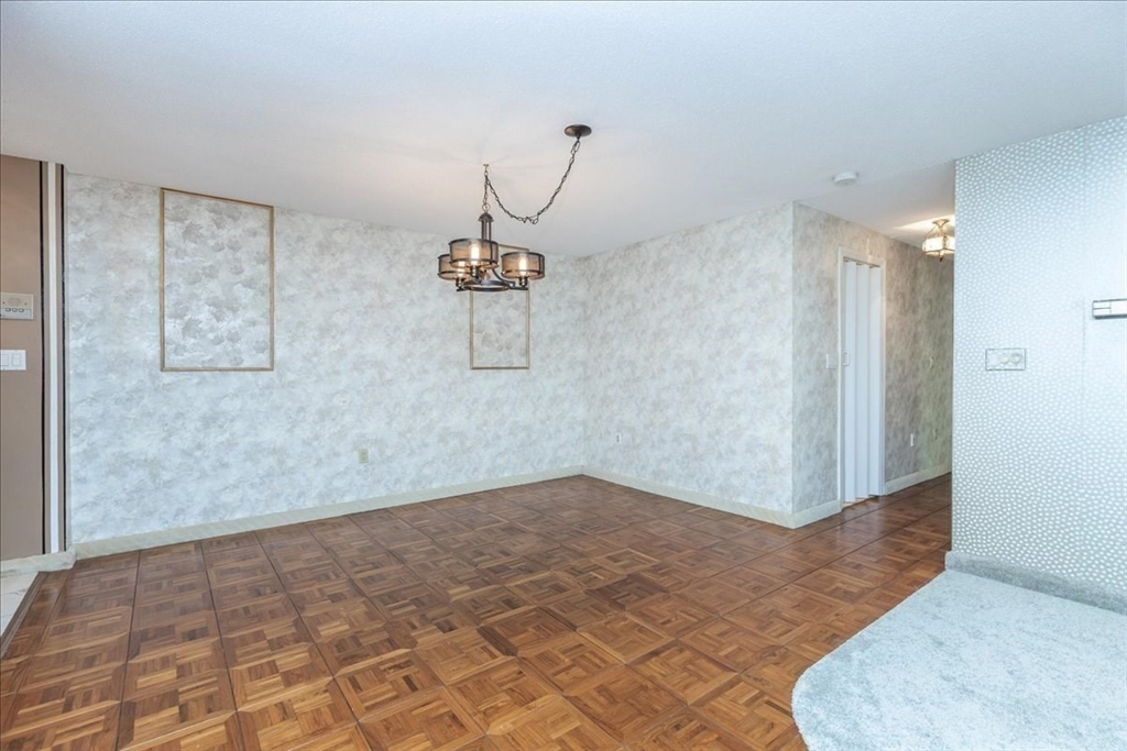 9 Ledgewood Way, Unit 9 Peabody, MA 01960 - Photo 12 of 42 a view of a room with wooden floor and glass doors