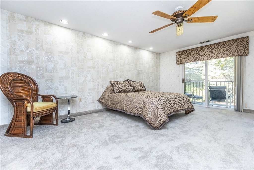 9 Ledgewood Way, Unit 9 Peabody, MA 01960 - Photo 27 of 42 a bedroom with a bed chair and window