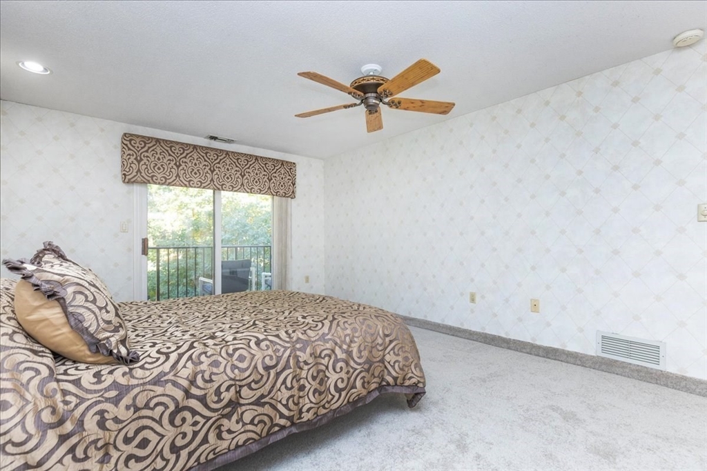 9 Ledgewood Way, Unit 9 Peabody, MA 01960 - Photo 28 of 42 a bedroom with a bed and a window