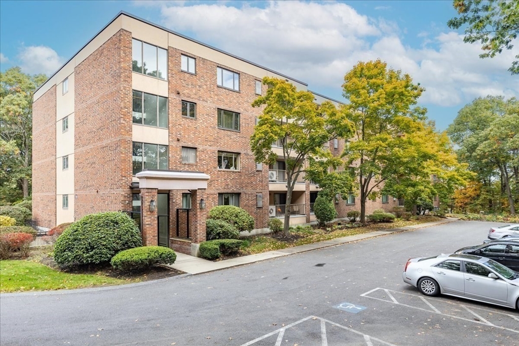 9 Ledgewood Way, Unit 9 Peabody, MA 01960 - Photo 4 of 42 a front view of a building with garden and parking