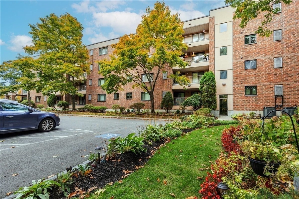 9 Ledgewood Way, Unit 9 Peabody, MA 01960 - Photo 5 of 42 a view of a parked cars in front of a building