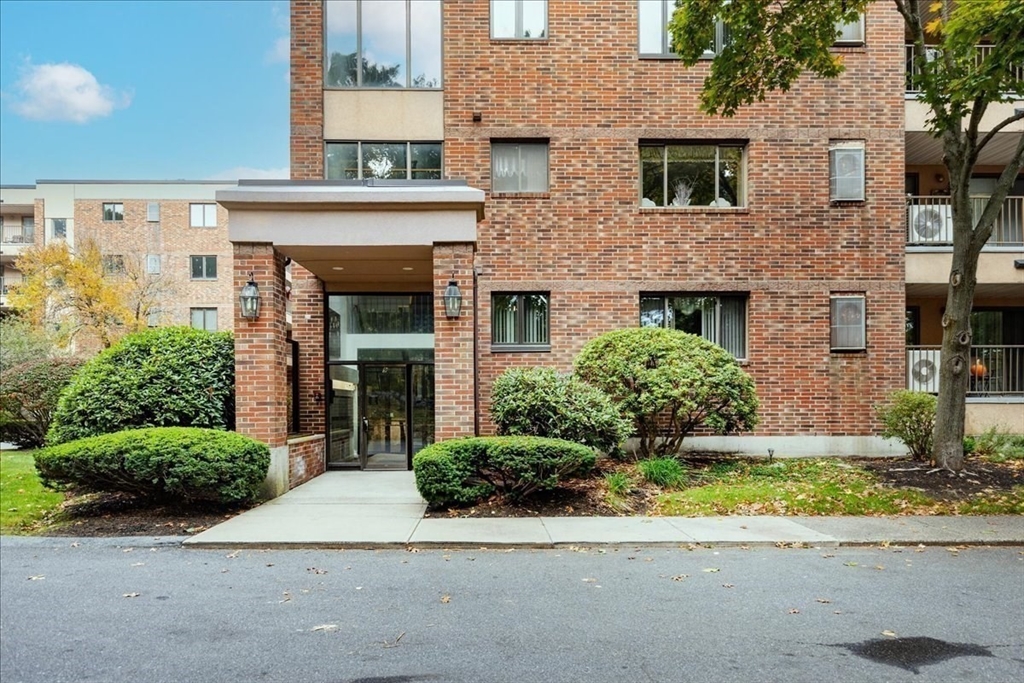 9 Ledgewood Way, Unit 9 Peabody, MA 01960 - Photo 6 of 42 a front view of a house with a yard garage and outdoor seating