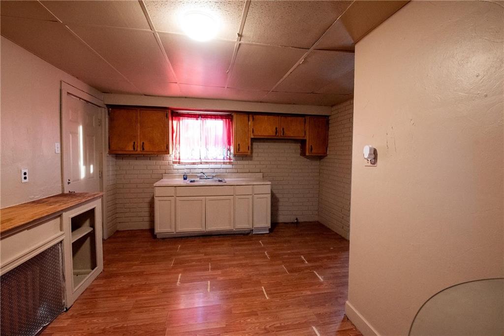 564 3rd Street Clairton, PA 15025 - Photo 14 of 20 a kitchen with a stove a sink and a refrigerator