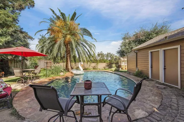 a view of a backyard with sitting area and furniture