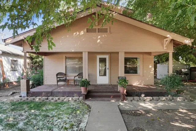 a front view of house with a garden